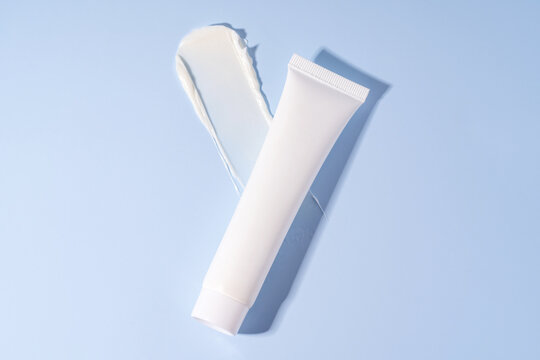 Skincare cream texture and tube on blue background