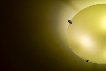 Close-up of the lamp in the house in warm tone with dark background. Lighting equipment.