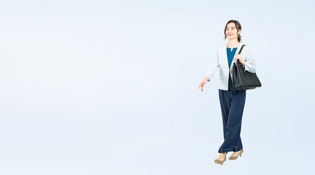 Full body photo of a Caucasian female business person walking. (We also sell PNGs that are cropped and have transparent background. Please search for "PNG" from the creator link.)