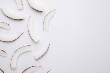 Pieces of fresh coconut on white background, top view - obrazy, fototapety, plakaty