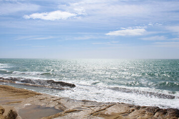 Fototapeta na wymiar waves on the beach,natural blue background, beautiful coast of the Mediterranean Sea in Alicante, Spain 