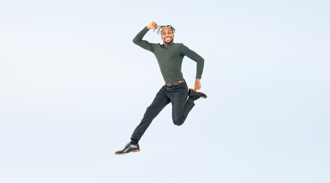 Full body photo of a black man jumping