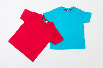 Two blank tshirts on a white background. Red and blue kids t-shirts