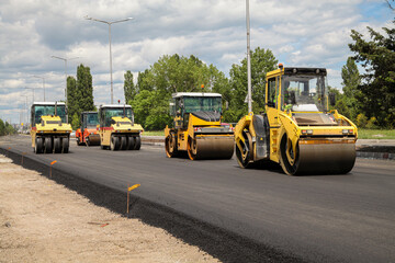 Group of heavy vibration roller compactors. Asphalting. Road construction