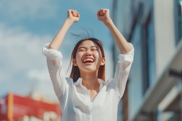 Excited young Asian business women celebrating successful project results, attracting important corporate client, dream goal achievement. Euphoric employee got increased salary or promotion