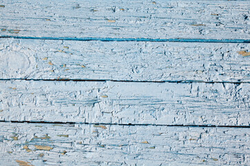 Old wooden surface with cracked blue paint