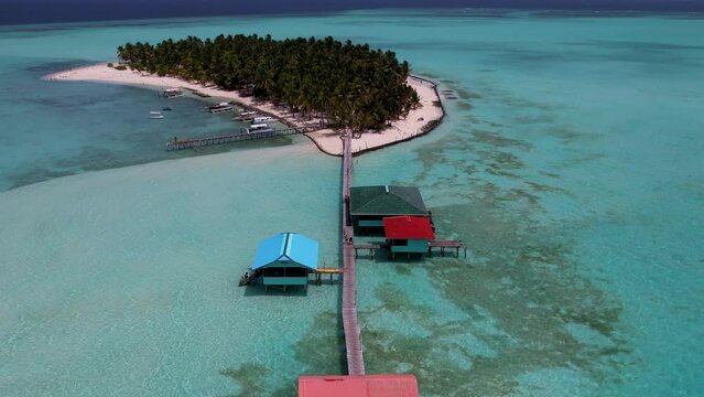 4K Aerial Drone video of beautiful tropical island Onok with white sand beaches, turtles, boats and turquoise blue water in Balabac, Philippines