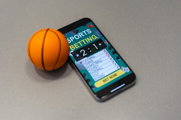 smartphone with application for sport bets and a basketball ball, concept of online bets  - 791721829