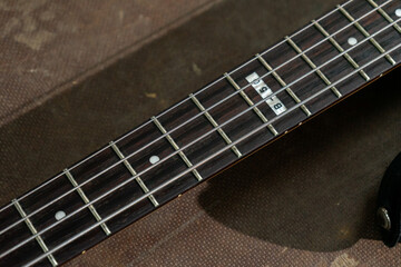 A close-up shot of bass guitar strings showcasing their texture and alignment. The image emphasizes...