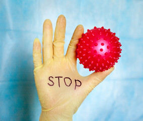 Stop Covid-19. Text on medical glove.