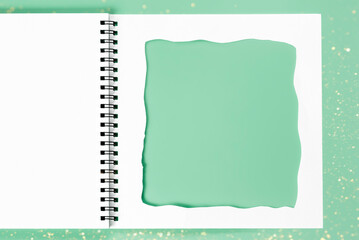 White notebook with cut-out frame on the page. Blank layout template of spiral notebook on pink...