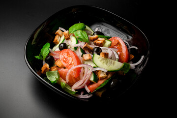 Greek salad of tomato, cucumber, chopped onion,bread croutons, and black olives - 791734889