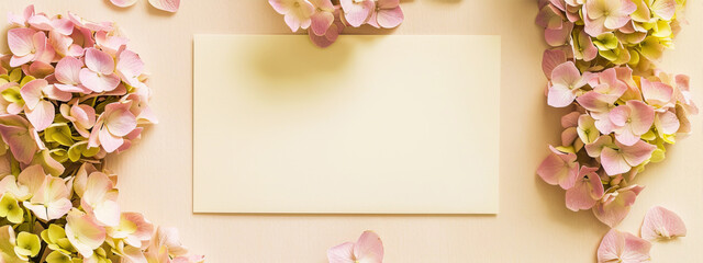 White, empty sheet on a yellow background with flowers
