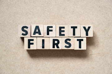 Alphabet letter block in word safety first on wood background