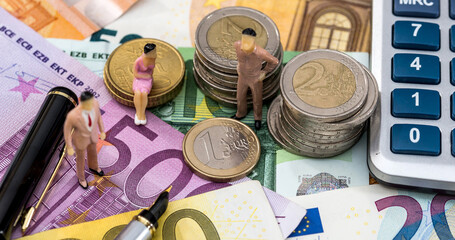 paper euros money with cent coin and a calculator on office desk. Accounting concept