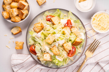 Fototapeta na wymiar Caesar Salad with Lettuce, Cheese, Cherry Tomatoes and Croutons