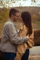 Fototapeta premium Young love and friendship: a teenage couple embraces by the lake, expressing first feelings and a kiss. Capturing the essence of a first date and romantic meeting spots, Valentine's Day