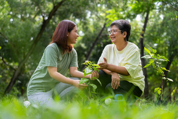 Old Asian Women and daughter join as volunteers for reforestation, earth conservation activities...