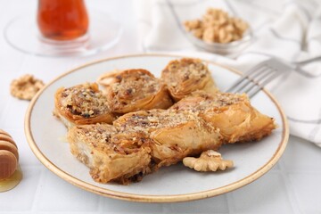 Eastern sweets. Pieces of tasty baklava on white tiled table, closeup