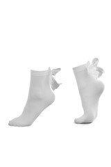 Close-up shot of a woman's white socks with bows. A pair of short nylon socks for women is isolated on a white background. Side view.