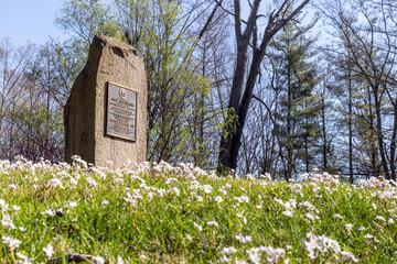 Monument to Potowanamie Chief Shipshewano in spring flowers. The Chief and his tribes were located on a small lake very near this monument. The nearby town of Shipshewana was named after the chief.