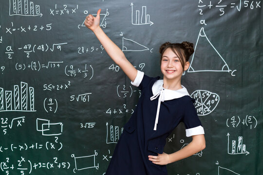Happy teenage schoolgirl rejoices at a good result in an exam, concept of success school life.
