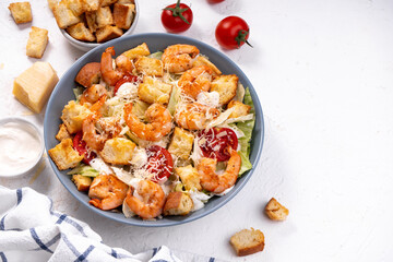 Shrimp Caesar Salad in a Bowl with Parmesan Cheese, Dressing and Croutons