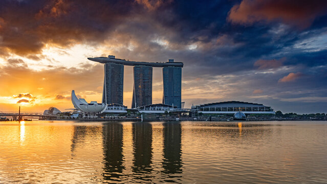 Singapore, Singapore – February 03, 2024: Skyline of Singapore Marina Bay with Marina Bay Sands, Art Science Museum during a dramatic sunrise with storm clouds