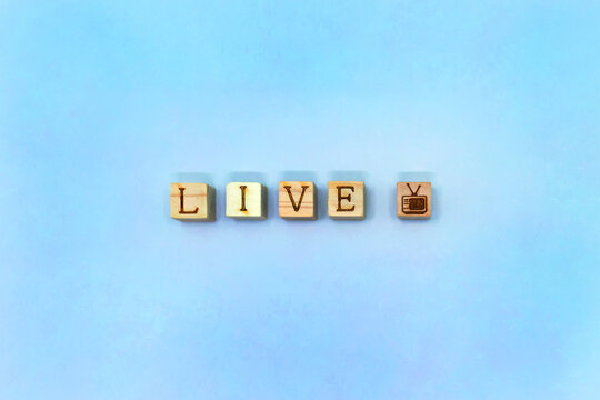 LIVEのアルファベットとテレビマークのブロックが中心に並ぶぼんやりとした淡い青紫色の背景