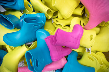  Childlike multi-colored rubber boots in the store . Top view