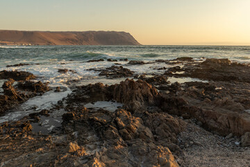 beach, rocks, sea, horizon line at sunset on La Lisera beach in Arica