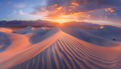 Fototapeta na wymiar Sun rising over the horizion, casting light over the seamlessly neverending pristine sand dunes 