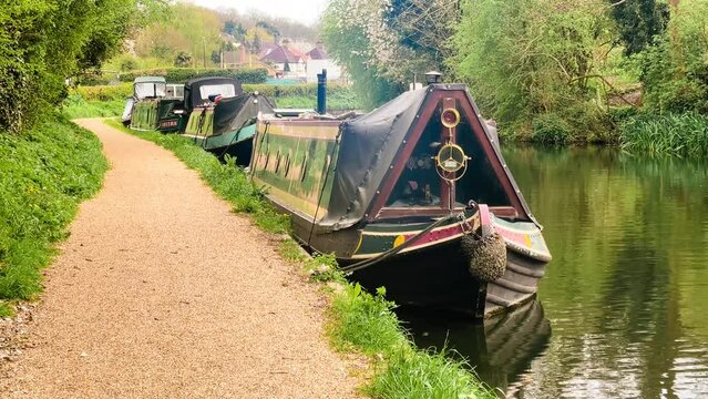 Scenic view of canal boat and picturesque waterway, surrounded by lush greenery and quaint countryside in Apsley, Hertfordshire, England, United Kingdom