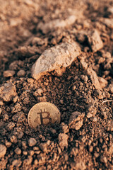 Bitcoin in plowed agricultural field soil