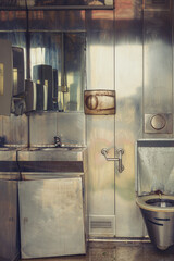 Old dirty public toilet with metallic interior - 791785491
