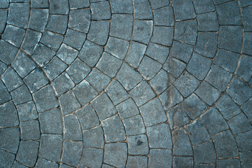 Cobblestone pattern of the sidewalk pavement from above as background and urban street texture