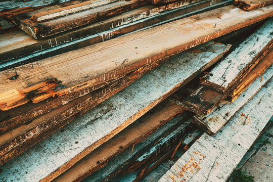 Pile of old worn used wooden boards and planks