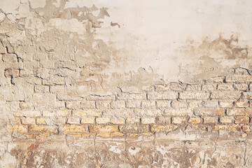 Background of old brickwall, texture of an worn facade made of bricks and mortar