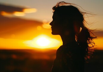 Silhouette against sunset: shadow reflects inner struggles, golden hues represent hope, resilience.