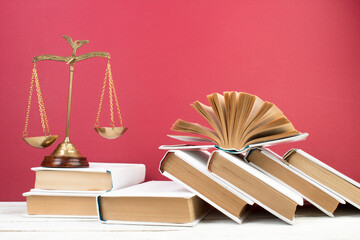 Law concept - Open law book, scales on table in a courtroom or law enforcement office. - 791794885