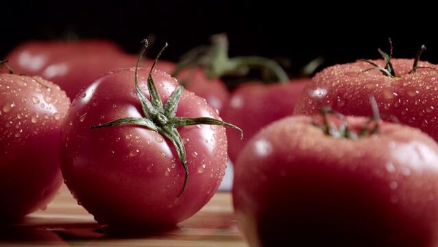 Embark on a sensory journey through the luscious world of ripe tomatoes with our mesmerizing stock footage, Ripe Beauty: Slow Pan Over Fresh Tomatoes Adorned with Dew Drops