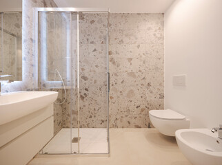 Inside a modern bathroom with marble tiles. - 791804220