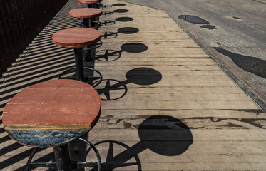 Round seats and tables on the pedestrian bridge .