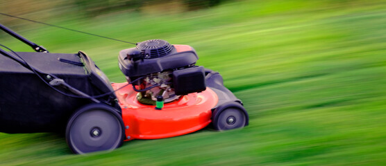 Red Lawn Mower in Lush Green Grass Mowing Lawn - 791809490