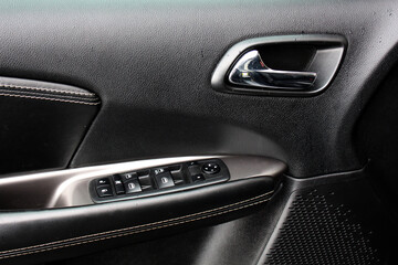 Car door control panel. Window lifters control. Car inside door handle. Armrest with setting...