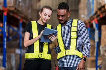 Warehouse worker working in warehouse storage. Foreman or worker work at factory site check up...