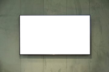 large flat screen TV mounted on a fabric wall
