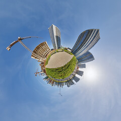 abstract swirling tiny planet spherical panorama of multi-storey buildings of skyscrapers of a residential complex in the form of a butterfly in blue sky - 791820220