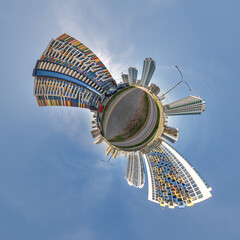 abstract swirling tiny planet spherical panorama of multi-storey buildings of skyscrapers of a residential complex in the form of a butterfly in blue sky - 791820288