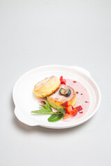 Freshly baked cottage cheese pancakes with berries on a plate